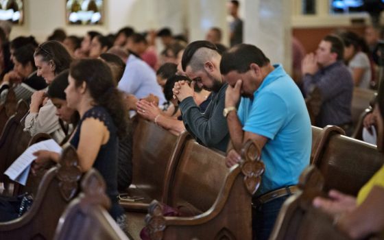 People pray during a healing Mass Aug. 7 at the Cathedral Shrine of the Virgin of Guadalupe in Dallas for the 31 victims killed in the mass shootings in El Paso, Texas, and Dayton, Ohio, Aug. 3 and 4. (CNS/The Texas Catholic/Jenna Teter)