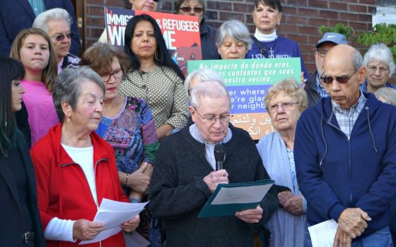 Fr. Jim Flynn, a retired priest of the Archdiocese of Louisville, Kentucky, reads a portion of a statement Oct. 8, 2019, at St. William Church that reaffirmed the parish’s commitment as a sanctuary church. (CNS/The Record/Jessica Able)