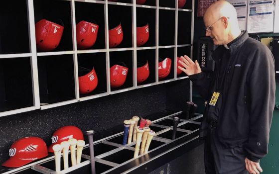 Msgr. Stephen Rossetti, a professor at the Catholic University of America and the chaplain for the Washington Nationals, blesses bats before a game during the 2019 season. (CNS/Courtesy of Msgr. Stephen J. Rossetti)