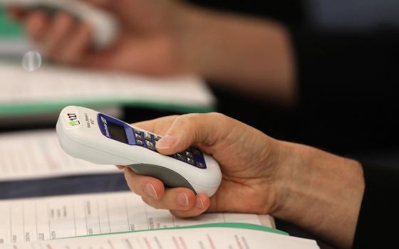 Bishops use electronic voting devices during the spring general assembly of the U.S. Conference of Catholic Bishops June 12, 2019, in Baltimore. During the 2021 virtual spring assembly, bishops voted by secret ballot June 17 to draft a document to address