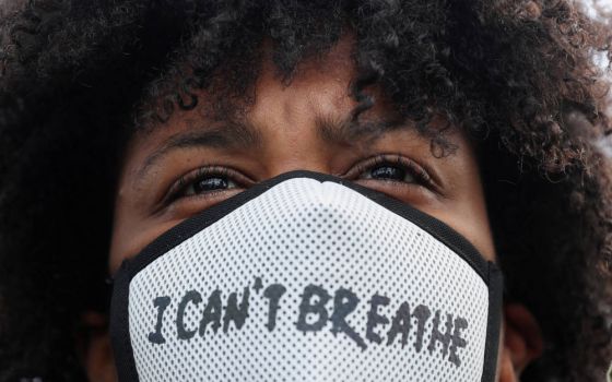 A demonstrator wearing a protective mask takes part in a protest in Rotterdam, Netherlands, June 3, 2020, following the death of George Floyd, an African American man who was taken into custody by Minneapolis police and later died at a Minneapolis hospita