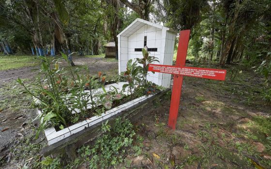 A red cross stands beside the grave of U.S.-born Sister Dorothy Stang in Anapu, Brazil, who was assassinated in 2005. The red cross beside her grave bears the names of 16 local rights activists who have been murdered since her killing. (CNS Photo/Paul Jef