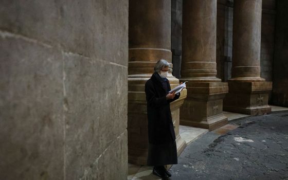 A worshipper wears a face mask to prevent the spread of COVID-19 on Holy Thursday in the Church of the Holy Sepulcher in Jerusalem's Old City April 1. This year, Joan Chittister celebrated Palm Sunday in a monastery still under a form of COVID-19 lockdown