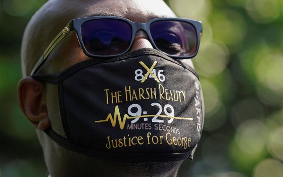 Philonise Floyd wears a face mask referencing his brother George's killing as he and other family members speak with reporters at the White House following their meeting with President Joe Biden in Washington May 25. (CNS/Reuters/Kevin Lamarque)