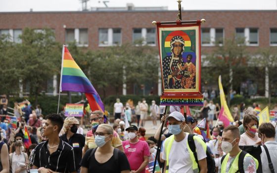 Activists carrying a rainbow flag and a banner with an image of Mary and the Christ Child attend the second "Marzahn Pride" march in Berlin July 17, 2021. (CNS photo/Axel Schmidt, Reuters)