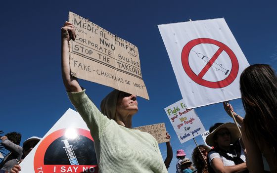Anti-vaccine protesters hold placards during a march against COVID-19 vaccinations Sept. 18 in Cape Town, South Africa. (CNS/Reuters/Mike Hutchings)