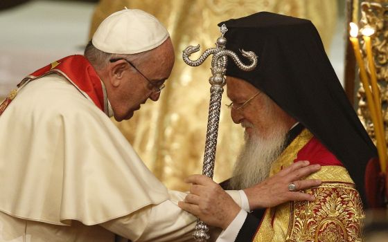 Pope Francis and Ecumenical Patriarch Bartholomew of Constantinople embrace during a prayer service in the patriarchal Church of St. George in Istanbul in this Nov. 29, 2014, file photo.  (CNS photo/Paul Haring)