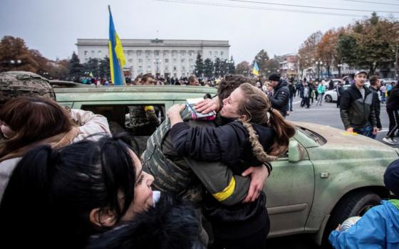 A local resident in Kherson, Ukraine, hugs a Ukrainian serviceman 