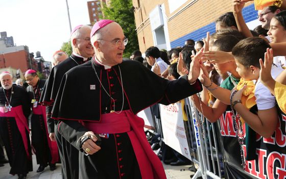 Archbishop Carlo Maria Viganò, then-apostolic nuncio to the U.S., greets children during Pope Francis' visit to Our Lady Queen of Angels School in East Harlem, New York, in this Sept. 25, 2015, file photo.  (CNS/The New York Times, pool/Eric Thayer)