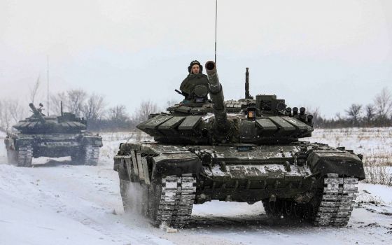 Members of the Russian armed forces drive tanks during military exercises in the Leningrad region of Russia in this handout photo released Feb. 14, 2022. (CNS photo/Russian Defense Ministry, Handout via Reuters)
