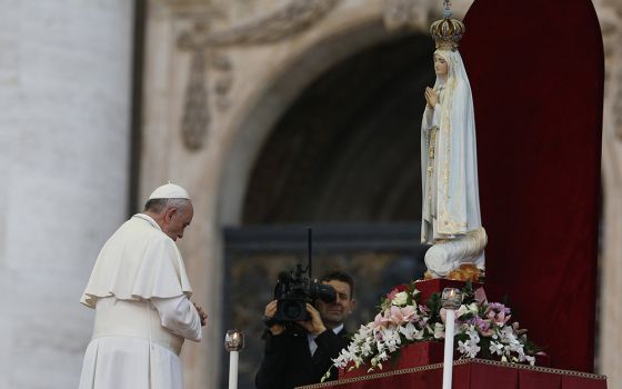 Pope Francis prays in front of the original statue of Our Lady of Fatima during a Marian vigil in St. Peter's Square at the Vatican on Oct. 12, 2013.