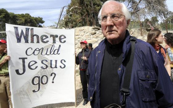 Retired Auxiliary Bishop Thomas Gumbleton of Detroit joins local Palestinians and international visitors for a Palm Sunday procession from Lazarus' tomb in Bethany to the Bethany Gate at the Israeli separation wall March 16, 2008, in the West Bank. (CNS)