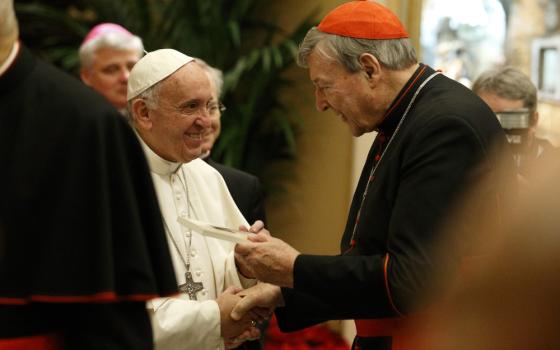 Pope Francis greets Australian Cardinal George Pell, prefect of the Secretariat for the Economy, during an audience to exchange greetings with members of the Roman Curia in Clementine Hall of the Apostolic Palace at the Vatican in this Dec. 22, 2016, file photo. Cardinal Pell, former prefect of the Vatican's Secretariat for the Economy, died Jan. 10 in Rome at the age of 81. (CNS photo/Paul Haring)