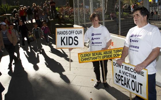 Australians protest clergy sexual abuse outside St. Mary's Cathedral in Sydney during Pope Benedict XVI's visit to celebrate World Youth Day in 2008. He met with the victims of abuse in Australia and in the U.S. that year. (CNS photo/Paul Haring)