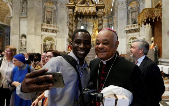 Cardinal Wilton Gregory poses for a selfie in St. Peter's Basilica at the Vatican.