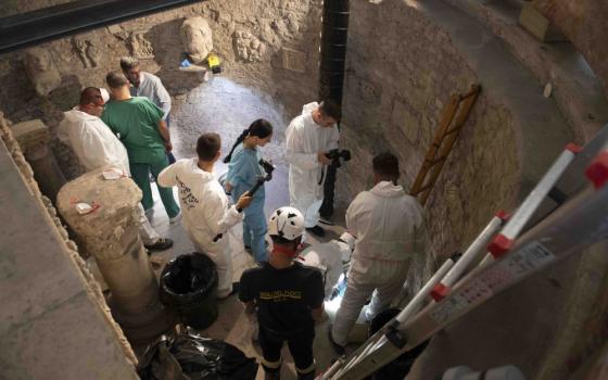 Workers inspect an ossuary at the Teutonic Cemetery at the Vatican in this July 20, 2019, file photo. The ossuary was inspected in the hope of finding the missing remains of a German princess and duchess and possibly the remains of Emanuela Orlandi, who disappeared in 1983. The Vatican prosecutor has opened a new investigation into the disappearance 40 years ago of Orlandi, the 15-year-old daughter of a Vatican employee. (CNS photo/Vatican Media) 