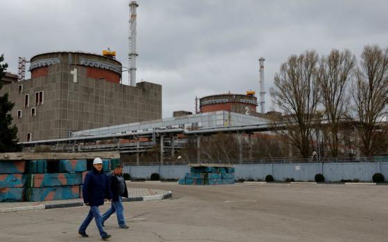 People walk outside the Zaporizhzhia Nuclear Power Plant in the course of Russia-Ukraine conflict outside Enerhodar in the Zaporizhzhia region, Russian-controlled Ukraine, March 29, 2023. (OSV News/Reuters/Alexander Ermochenko)