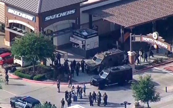 Military-style vehicles and people in dark outfits mill outside a Sketchers in a mall