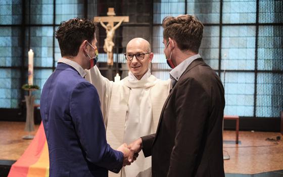 Fr. Christian Olding blesses a gay couple during the blessing service "Love Wins" in the Church of St. Martin in Geldern, Germany, May 6, 2021. (OSV News/KNA/Rudolf Wichert)