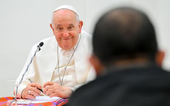 Pope Francis smiles as he meets with some 30 priests — Canossian Fathers and priests from the Diocese of Rome — in the pastoral center of St. George of Acilia Parish in south Rome Dec. 21, 2023. (CNS/Vatican Media)