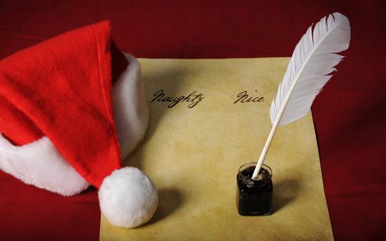 Naughty and nice list with a santa hat and an inkwell with quill (Dreamstime/R. Gino Santa Maria/Shutterfree, Llc)