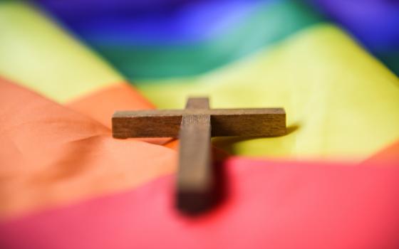 A wooden cross lies on a rainbow flag in Bonn, Germany, March 16, 2021. Catholic bishops across Eastern Europe are reacting negatively to the Vatican's recent decree allowing for priests to offer blessings for same-sex couples, Alex Fauldy writes. (OSV News/KNA/Julia Steinbrecht)
