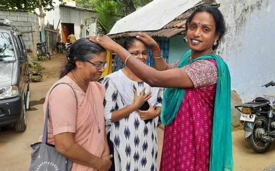 Kovai Meera, a trans woman, blesses Srs. Stella Baltazar and Anita Edwin, members of the Franciscan Missionaries of Mary, at her residence in Coimbatore, a major city in Tamil Nadu state in southern India. (Saji Thomas)