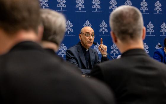 Cardinal Víctor Manuel Fernández, prefect of the Dicastery for the Doctrine of the Faith, speaks at a news conference to present the dicastery's declaration Dignitas Infinita at the Vatican press office April 8. Priests from the dicastery's doctrinal section joined reporters for the presentation. (CNS/Pablo Esparza)