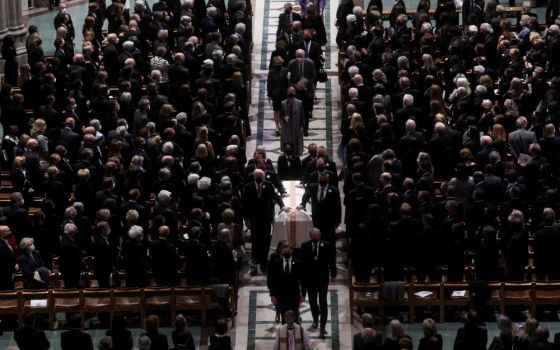 Mourners at the Washington National Cathedral in Washington stand April 27 as the casket of former Secretary of State Madeleine Albright is carried during a funeral procession. Albright, the first woman to serve as U.S. secretary of state, died March 23.