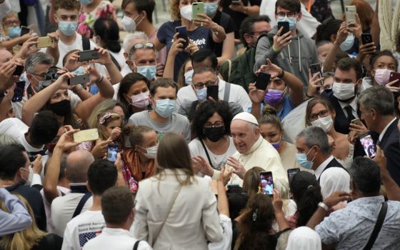 Pope Francis stops to greet the faithful as he leaves after the Aug. 25 weekly general audience at the Vatican. (AP/Gregorio Borgia)