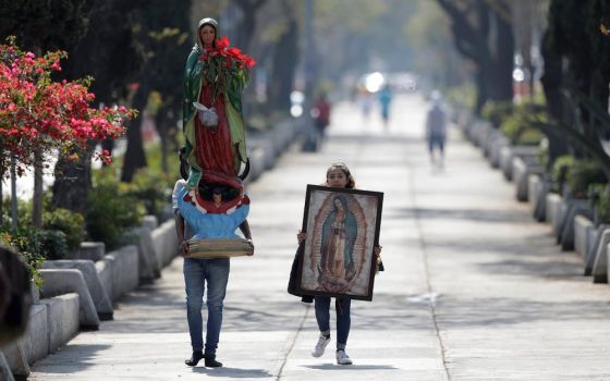Pilgrims carry a statue and image of Our Lady of Guadalupe near the basilica in her name in Mexico City Dec. 12, 2020, during the COVID-19 pandemic. The basilica was closed that day to avoid crowds during Our Lady of Guadalupe feast day celebrations. (CNS