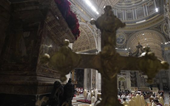A cross is seen as Pope Francis celebrates Christmas Eve Mass, which was not open to the public, in St. Peter's Basilica at the Vatican Dec. 24, 2020. (CNS/Vatican Media)