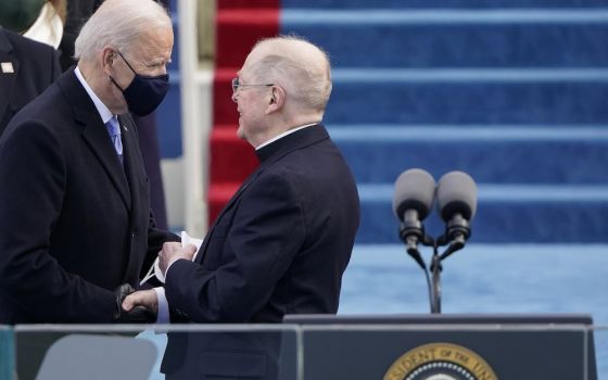 Joe Biden greets Jesuit Fr. Leo O'Donovan during Biden's inauguration as the 46th president of the United States at the U.S. Capitol in Washington Jan. 20, 2021. (CNS/Reuters pool/Patrick Semansky)