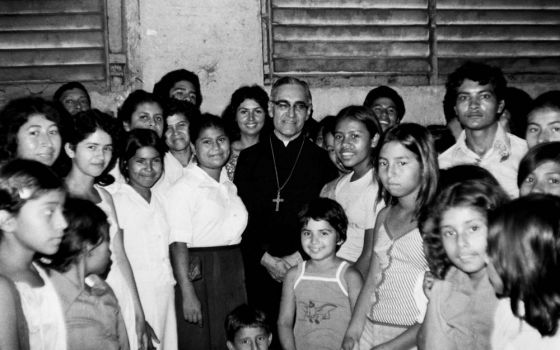 Óscar Romero with women and children