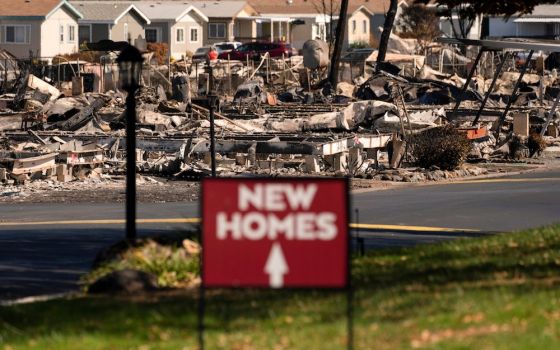 A sign in Medford, Oregon, advertises new homes amid the wildfire destruction Sept. 20, 2020. (CNS photo/David Ryder, Reuters)