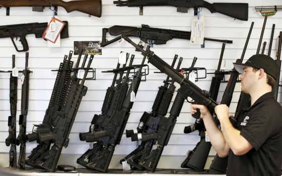 A salesman clears the chamber of an AR-15 in 2016 at a gun store in Provo, Utah. (CNS/Reuters/George Frey)