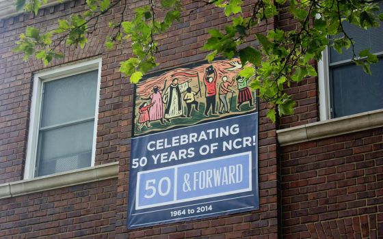 A banner celebrating the National Catholic Reporter's 50th anniversary is seen on the company's headquarters in Kansas City, Missouri. (NCR photo/Teresa Malcolm)
