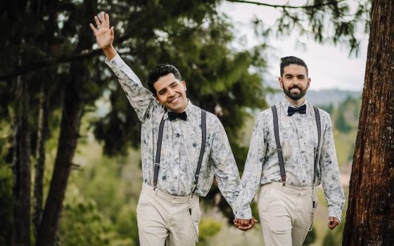 Two men walk holding hands on their wedding day in November 2020. (Juan Arango)