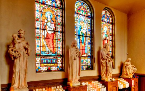 Statuary and stained-glass windows at St. Stanislaus Kostka Church in Pittsburgh: An evening Mass on the first Friday of every month has been attracting young people to the church. (Wikimedia Commons/Bestbudbrian)