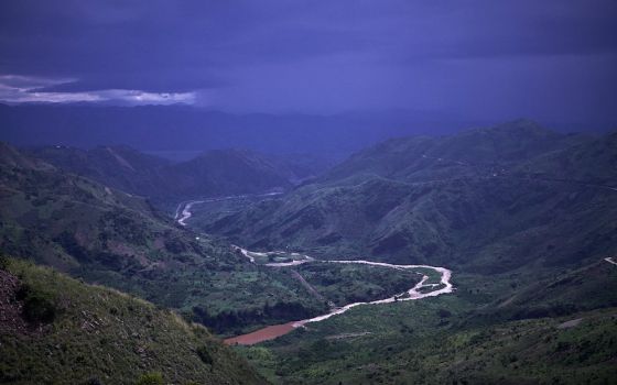 Mountains and the country of Rwanda are seen across the Ruzizi River near Bukavu, Democratic Republic of Congo, in 2014. The Congolese bishops have sharpened their focus on protecting the Congo Basin. (CNS photo/Sam Phelps, CRS)