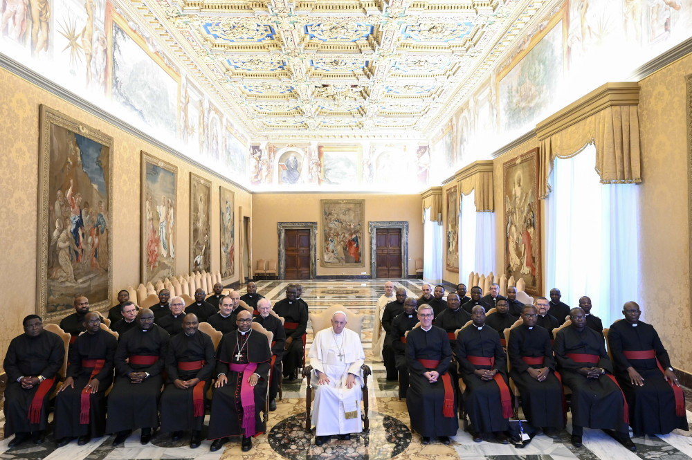 Pope Francis poses for a photo with members of the general chapter of the Mariannhill Missionaries during an audience Oct. 20, 2022, in the Consistory Hall of the Apostolic Palace at the Vatican. Bishop Thulani Victor Mbuyisa of Kokstad, South Africa, left of the pope, was superior general of the order until April, when he was named a bishop. To the right of the pope is Mariannhill Father Michael Mass, newly elected superior of the order.