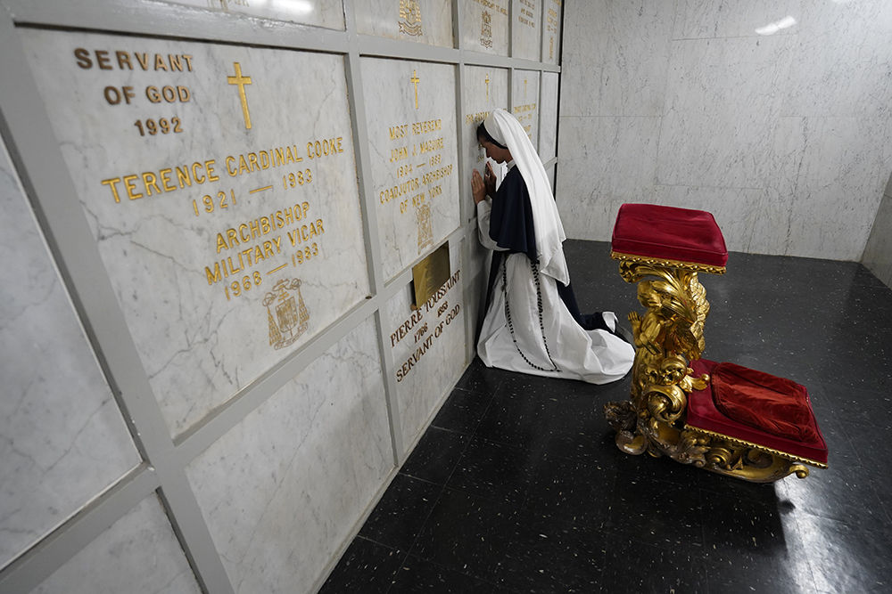 Sr. Mary Grace prays at the tomb of New York Cardinal John O'Connor before she and six other members of the Sisters of Life professed their perpetual vows during a special Mass at St. Patrick's Cathedral in New York City Aug. 5. The Sisters of Life were founded by Cardinal O'Connor in 1991. (OSV News/Gregory A. Shemitz)