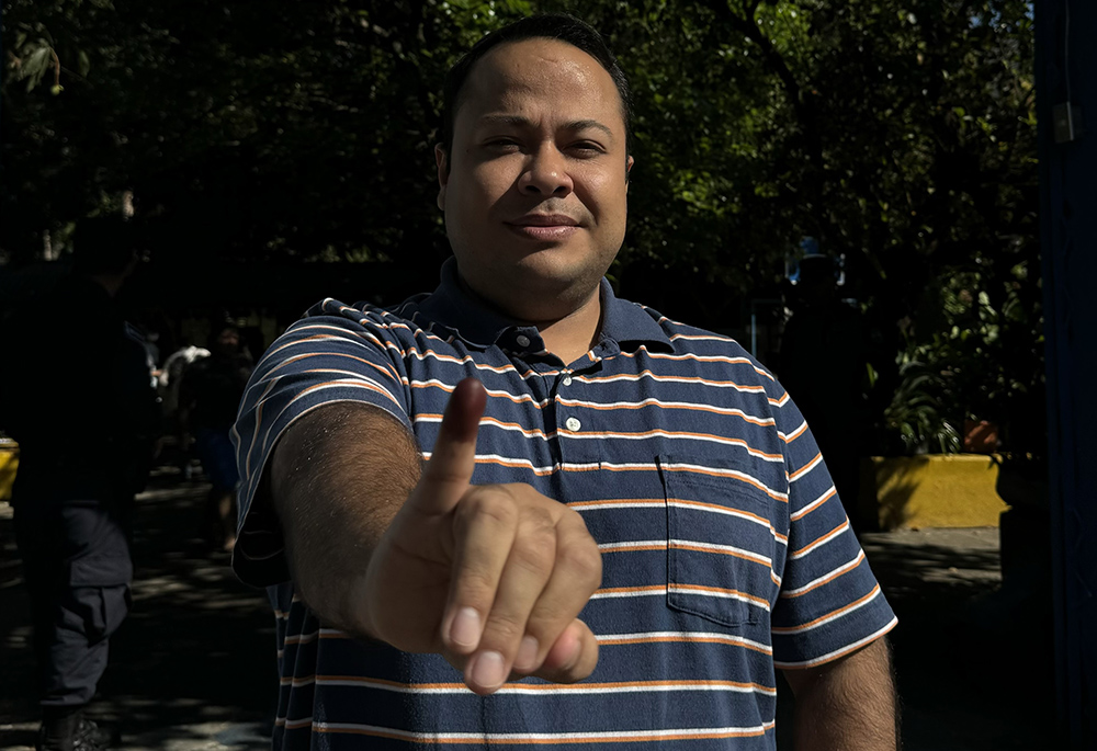 Felipe Abrego shows his tinted finger, proof of voting in presidential and legislative elections Feb. 4 in Chalatenango, El Salvador. (NCR photo/Rhina Guidos)