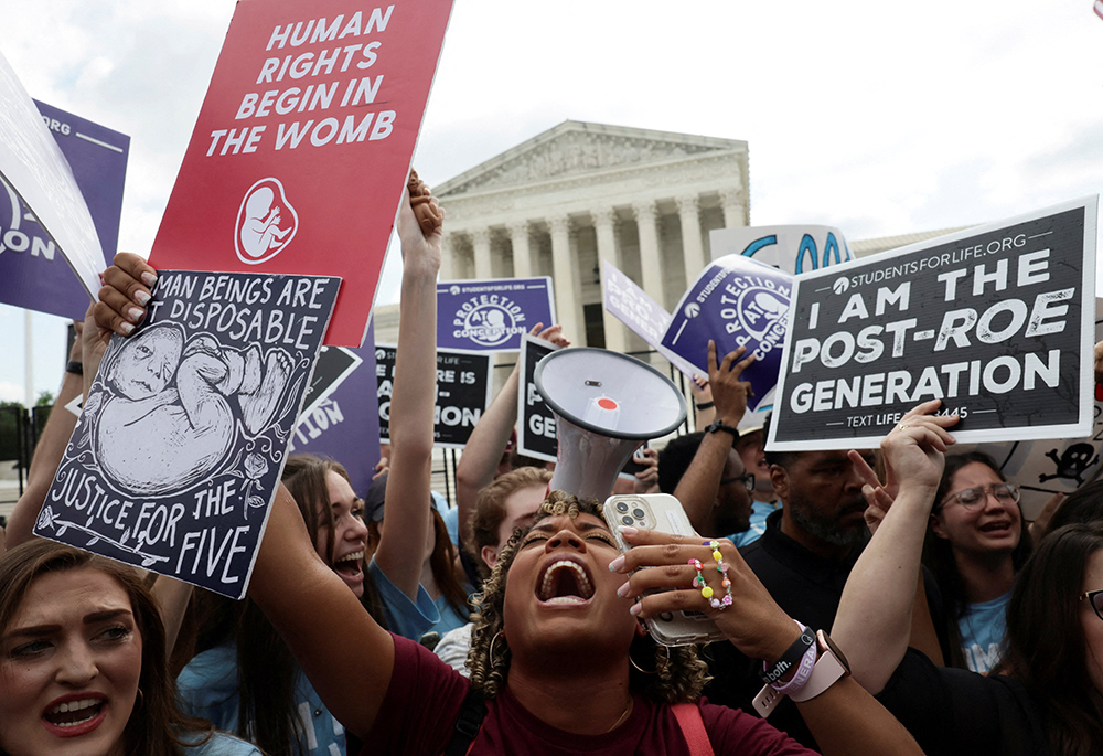 Pro-life demonstrators in Washington celebrate outside the U.S. Supreme Court June 24, 2022, as the court overruled its landmark Roe v. Wade abortion precedent in its Dobbs v. Jackson Women's Health Organization ruling. The case involved a Mississippi law banning most abortions after 15 weeks. (OSV News/Reuters/Evelyn Hockstein)