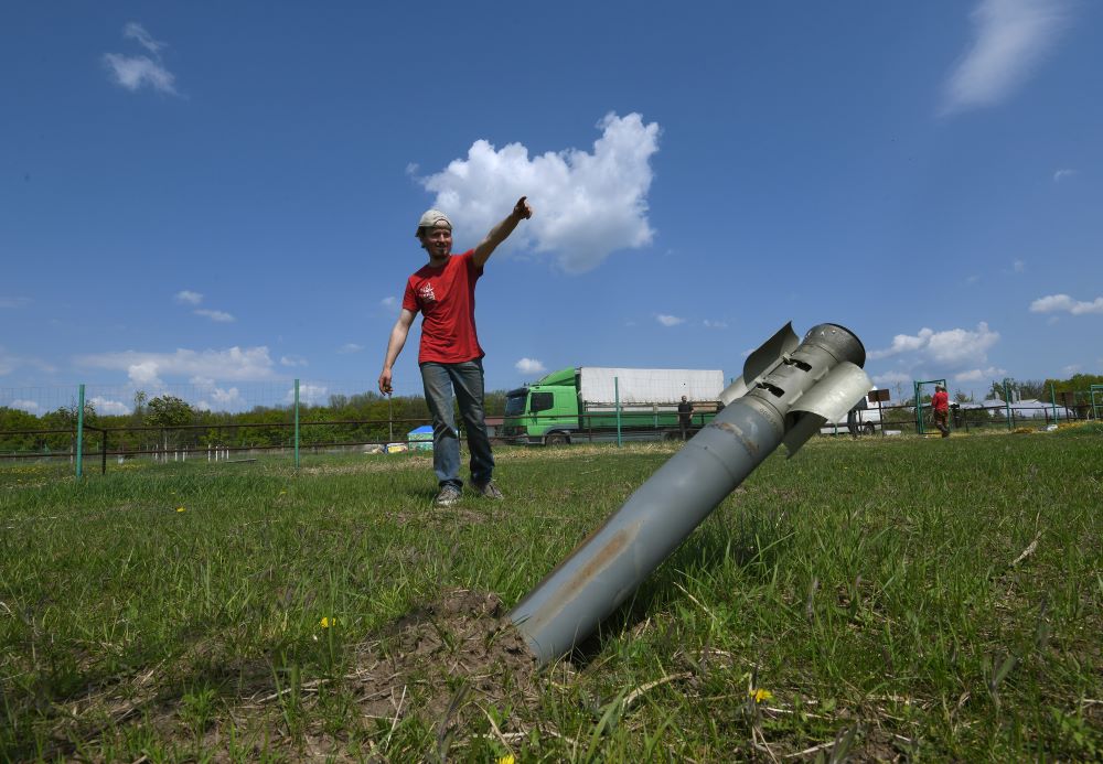 Timothy, a volunteer for the evacuation of the animals at Feldman Ecopark, helps direct the high-risk rescue amidst the debris of Russian missiles.