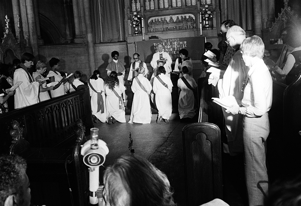 Jeannette Piccard kneels in the center, third from right, during the ordination service at Church of the Advocate, July 29, 1974, in Philadelphia. Piccard was ordained to the Episcopal priesthood 40 years after her flight into the stratosphere. (Brad Hess)