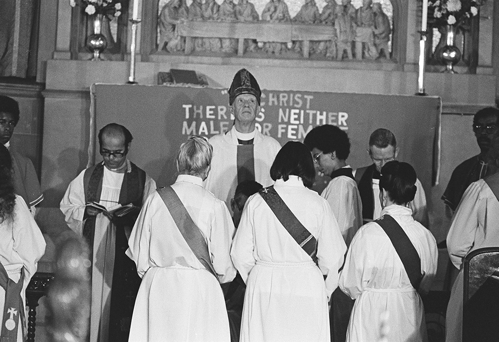 Jeannette Piccard, Betty Bone Schiess, and Alla Bozarth (kneeling) are pictured with Bishop Edward Welles (center) during the ordination service at the Church of the Advocate, July 29, 1974, in Philadelphia. The 11 women ordained that day became known as the Philadelphia Eleven. (Brad Hess)