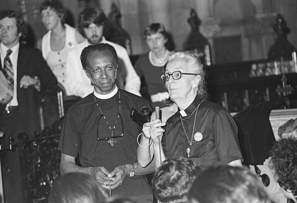 Jeannette Piccard speaks to reporters after the ordination service in which she and 10 other women became the first women ordained to the Episcopal priesthood in the U.S., on July 29, 1974, in Philadelphia. The Rev. Paul Washington, rector of the Church of the Advocate, stands to her left. (Brad Hess)