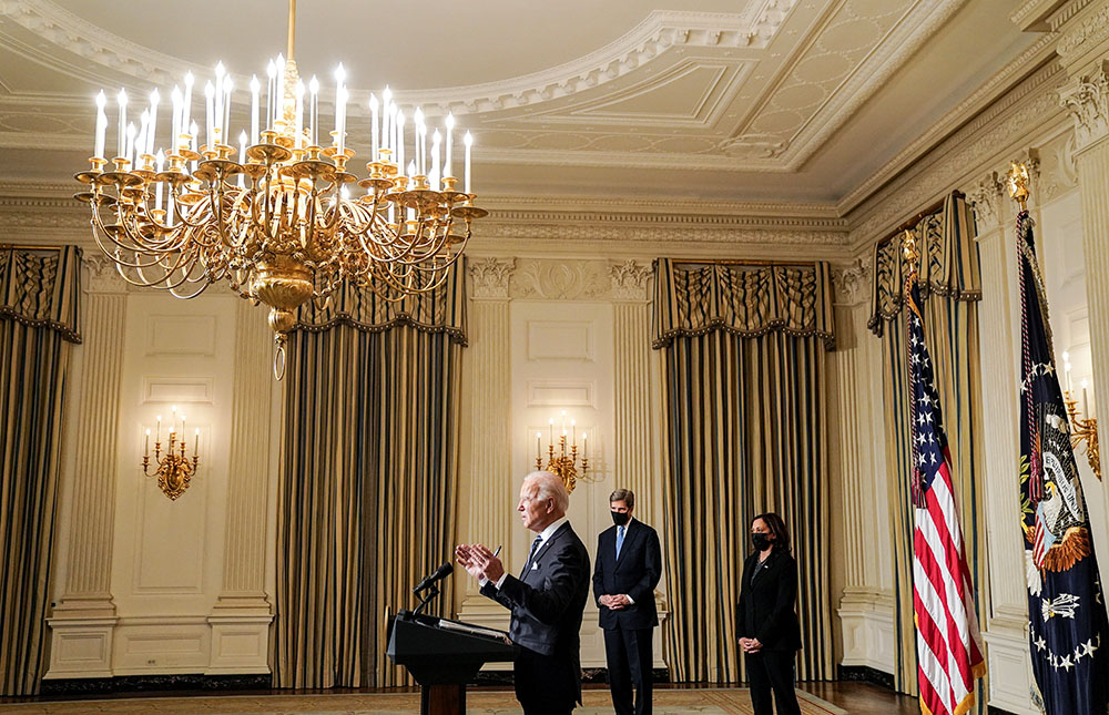 President Joe Biden delivers remarks on tackling climate change at the White House in Washington Jan. 27, 2021, prior to signing executive actions. Also pictured are John Kerry, then special presidential envoy for climate, and Vice President Kamala Harris. (CNS/Reuters/Kevin Lamarque)