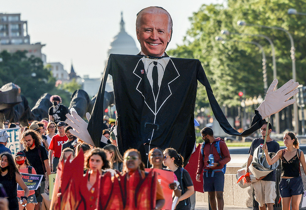 Environmental activists in Washington march toward the White House June 30, 2021, to demand that President Joe Biden stop fossil fuel projects and put climate justice at the heart of his infrastructure plans. (CNS/Reuters/Evelyn Hockstein)